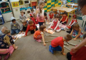 Dzieci na dywanie układają szkielet człowieka